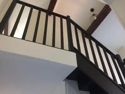a staircase with black and white railings in a house at Inn CLOUDS Cannes in Cannes