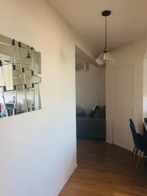 a living room with a table and a couch at Inn CLOUDS Cannes in Cannes