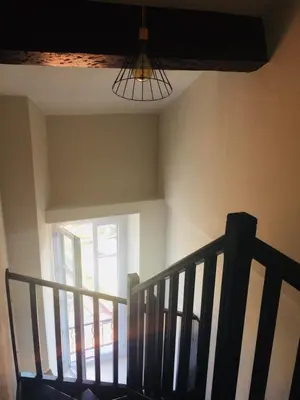 a staircase in a house with a window and a chandelier at Inn CLOUDS Cannes in Cannes