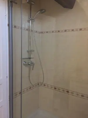 a shower with a shower head in a bathroom at Inn CLOUDS Cannes in Cannes
