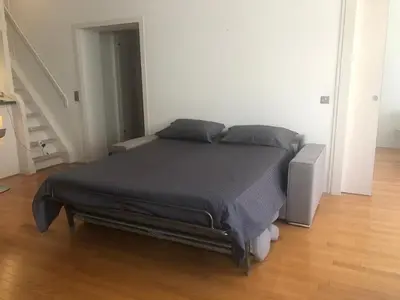 a bedroom with a bed in a white room at Vieux port de Cannes in Cannes