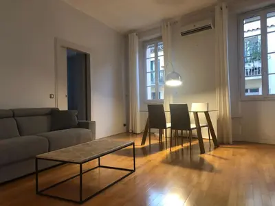a living room with a couch and a table and chairs at Vieux port de Cannes in Cannes