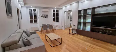 a living room with a couch and a flat screen tv at Vieux port de Cannes in Cannes