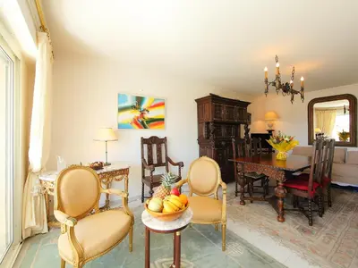 a living room with chairs and a table with a bowl of fruit at Apartment Riviera Park-1 by Interhome in Cannes