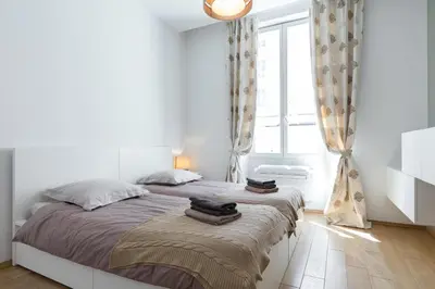 a bedroom with a large bed with two towels on it at Le St Honoré in Cannes