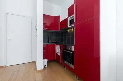 a kitchen with red cabinets and a red refrigerator at Le St Honoré in Cannes