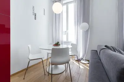 a living room with a couch and a table and chairs at Le St Honoré in Cannes