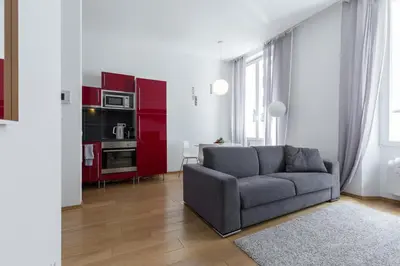 a living room with a couch and red cabinets at Le St Honoré in Cannes