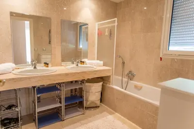 a bathroom with two sinks and a tub and a toilet at Leisure Apartment by Connexion in Cannes