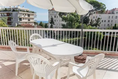 a kitchen with white cabinets and a white refrigerator at Leisure Apartment by Connexion in Cannes