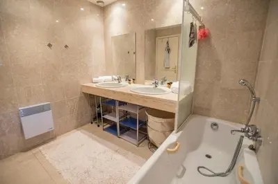 a bedroom with a white bed and a fan at Leisure Apartment by Connexion in Cannes