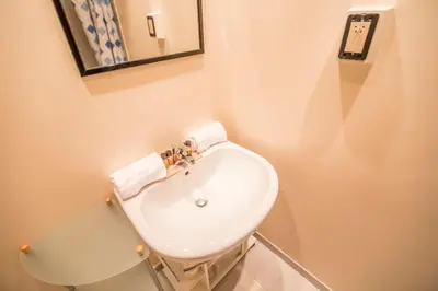 a bathroom with a white sink and a mirror at Leisure Apartment by Connexion in Cannes