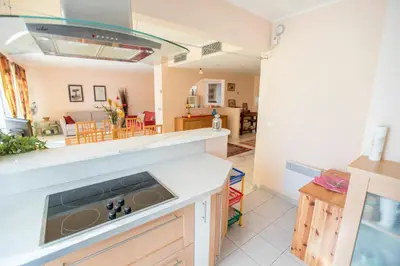a white table and chairs on a balcony with an umbrella at Leisure Apartment by Connexion in Cannes
