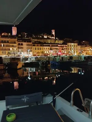 a view of a marina at night with boats in the water at Ferretti 36 ' Bateau à Quai Vieux-Port Cannes Festival La Croisette in Cannes