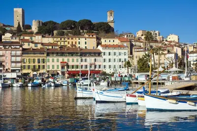 a group of boats docked in a harbor with buildings at Ferretti 36 ' Bateau à Quai Vieux-Port Cannes Festival La Croisette in Cannes