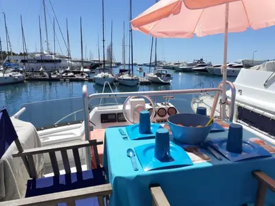 a table on a boat in a marina with boats at Ferretti 36 ' Bateau à Quai Vieux-Port Cannes Festival La Croisette in Cannes
