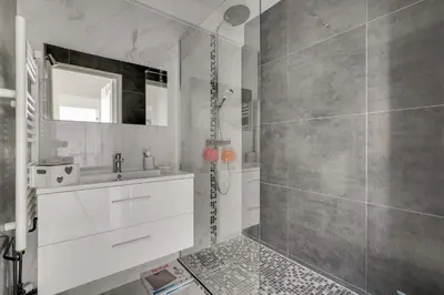 a white bathroom with a shower and a sink at Superb 1 bedroom appartement - close to Croisette in Cannes