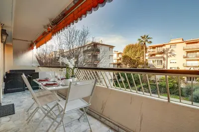 a balcony with a table and chairs on a balcony at Superb 1 bedroom appartement - close to Croisette in Cannes