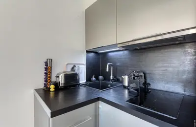 a kitchen with a sink and a counter top at Cannes Croisette Concorde Miramar in Cannes