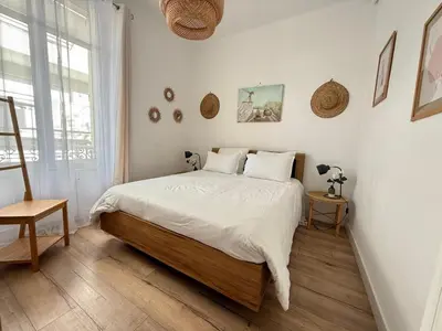 a bedroom with a large bed with white sheets at Le Salvator in Cannes