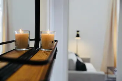 two candles on a wooden table in a room at Le Salvator in Cannes