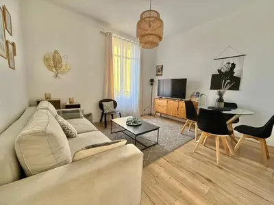 a living room with a couch and a table at Le Salvator in Cannes