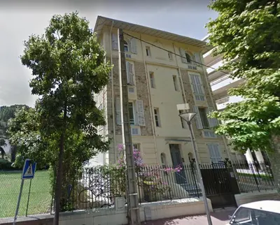 a building with a fence in front of it at Le Salvator in Cannes