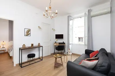 a living room with a couch and a desk at 2 rooms apartment, near the sea and local market in Cannes