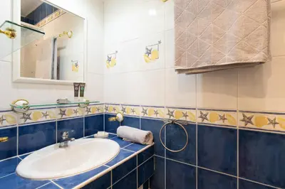 a bathroom with a sink and a mirror at 2 rooms apartment, near the sea and local market in Cannes