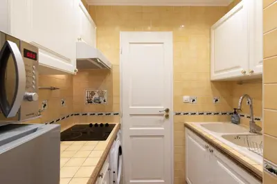 a kitchen with a sink and a white door at 2 rooms apartment, near the sea and local market in Cannes