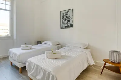 two beds in a white room with white sheets at IMMOGROOM - EXCLUSIVE - Terrace - Amazing quiet place - Wifi in Cannes