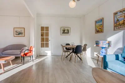 a living room with a blue couch and a table at IMMOGROOM - EXCLUSIVE - Terrace - Amazing quiet place - Wifi in Cannes