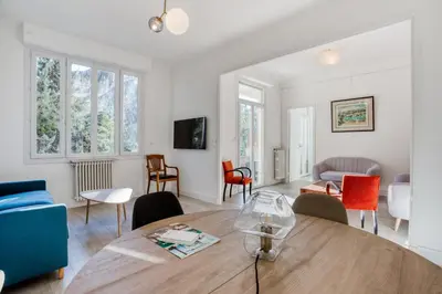 a living room with a table and chairs at IMMOGROOM - EXCLUSIVE - Terrace - Amazing quiet place - Wifi in Cannes