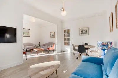 a living room with a blue couch and a table at IMMOGROOM - EXCLUSIVE - Terrace - Amazing quiet place - Wifi in Cannes