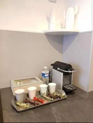 a tray with cups on a counter in a kitchen at Studio Cosy centre Cannes in Cannes