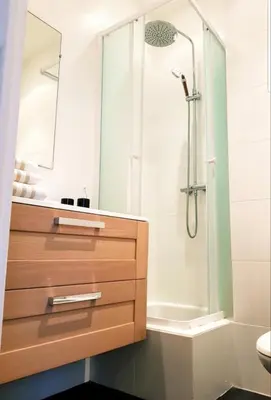 a bathroom with a shower and a sink and a drawer at Studio Cosy centre Cannes in Cannes