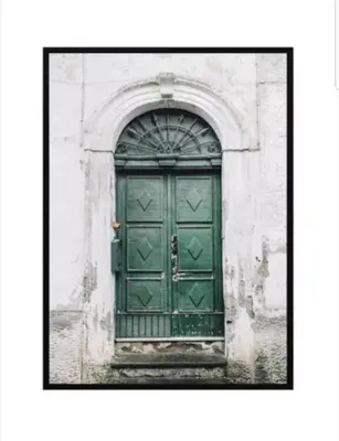 a green door in a building with an arch at Studio Cosy centre Cannes in Cannes