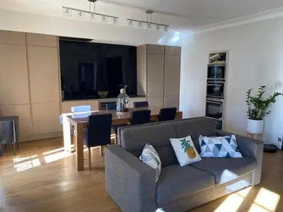 a living room with a couch and a dining table at Pavillon Geneve in Cannes