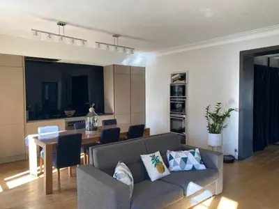 a living room with a couch and a table at Pavillon Geneve in Cannes