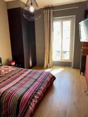 a bedroom with a bed and a large window at Pavillon Geneve in Cannes