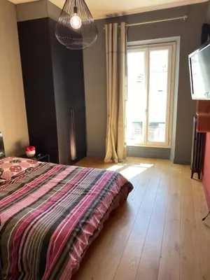 a bedroom with a bed and a television and a window at Pavillon Geneve in Cannes