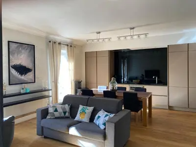 a living room with a couch and a table at Pavillon Geneve in Cannes
