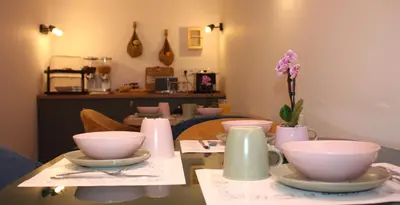 a table with bowls and vases on top of it at Charlie's Hôtel Cannes in Cannes