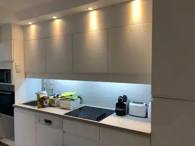 a kitchen with white cabinets and a counter top at Luxe apartment center 6pers 300m2 privare garden in Cannes