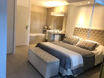 a bedroom with a large bed and a bath tub at Luxe apartment center 6pers 300m2 privare garden in Cannes
