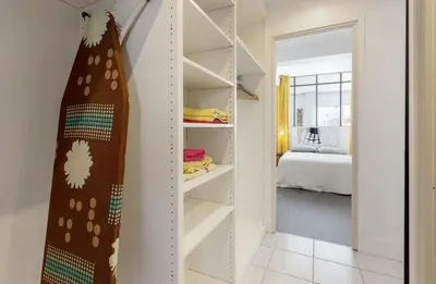 a room with a book shelf and a bedroom at CANNES Festival Films Center, with 2 bedrooms and balcony in Cannes