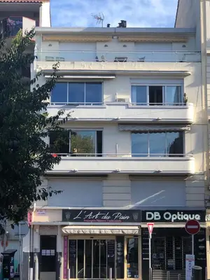a white building with a dc appliance sign in front of it at CANNES Festival Films Center, with 2 bedrooms and balcony in Cannes