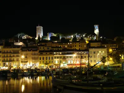 a group of boats docked in a harbor at night at carré d'or rue d'ANTIBES à quelques pas du palais des Festivals in Cannes