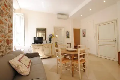 a living room with a couch and a table and chairs at Frères Pradignac in Cannes