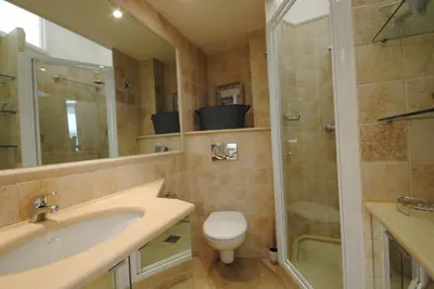 a bathroom with a sink and a shower and a toilet at Frères Pradignac in Cannes